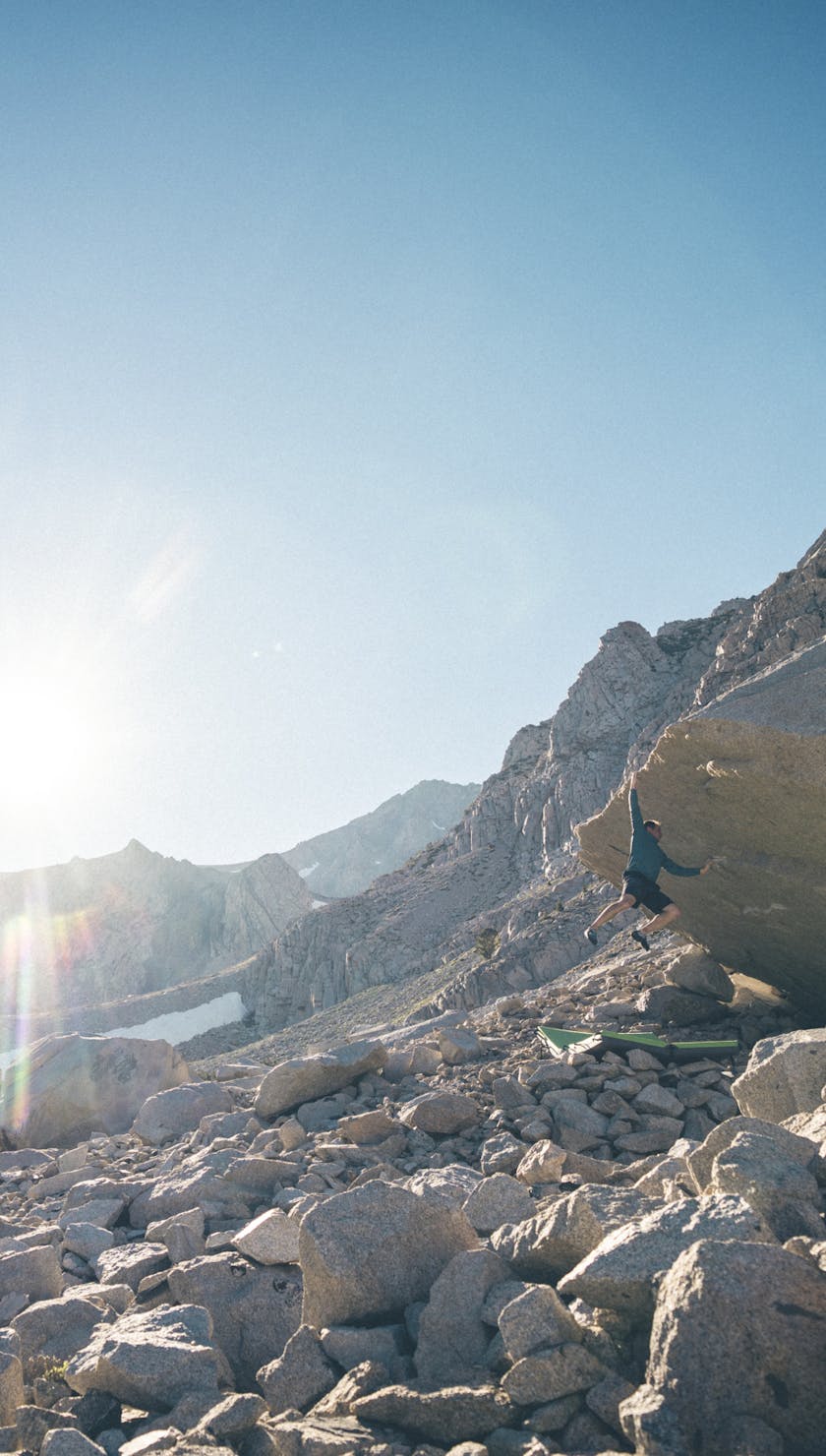 Alpenglow Family. BD athlete Carlo Traversi bouldering in the high Sierra sun. 