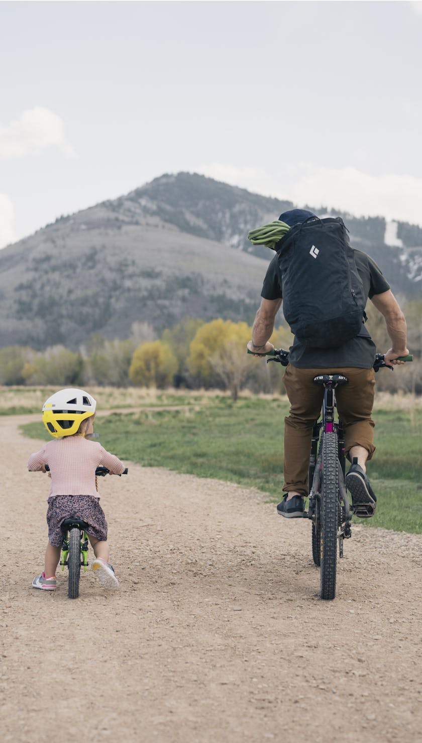 Fathers Day. A climber rides bikes with their daughter. 