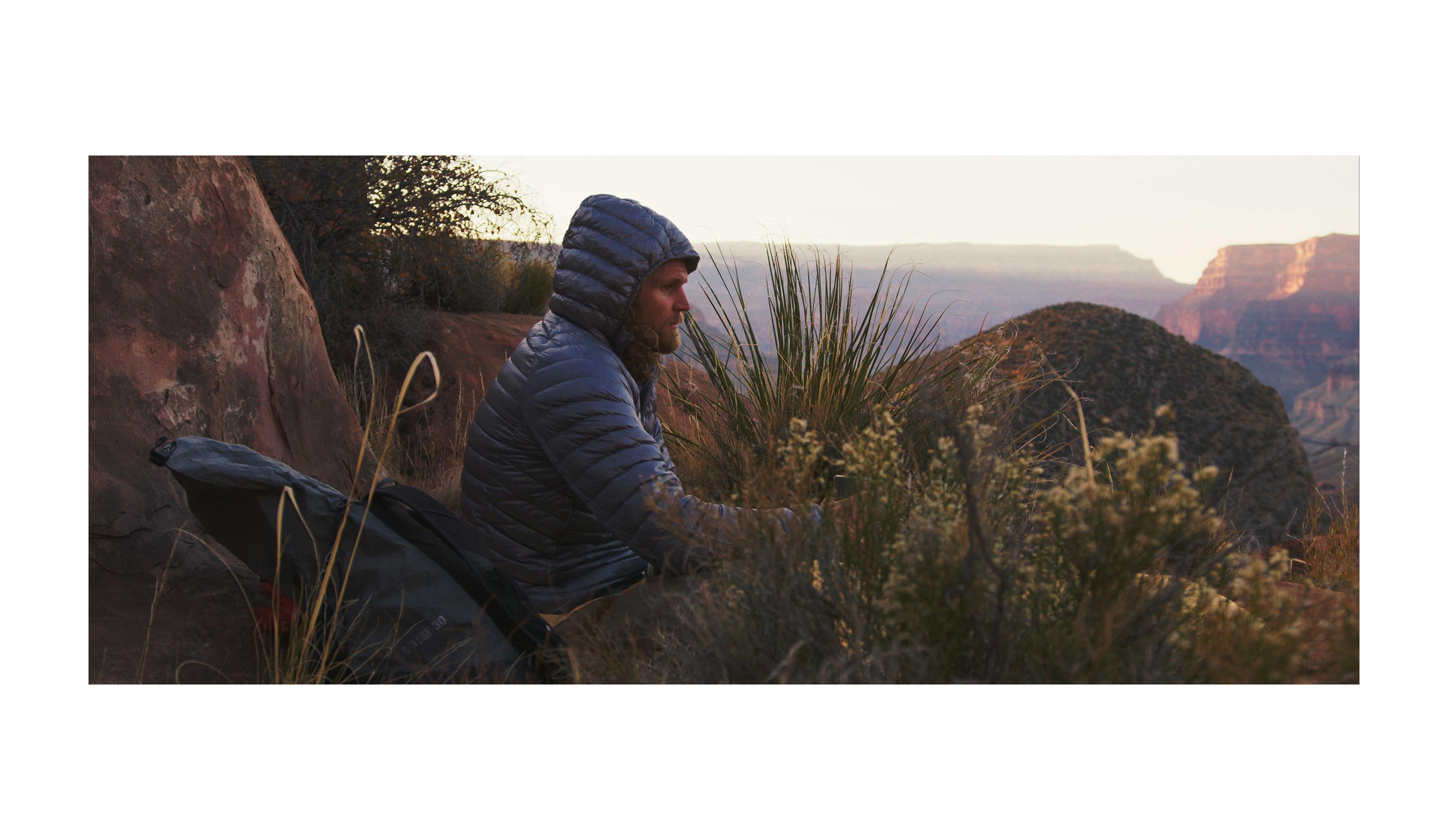 Joe Grant rests on the rim of the Grand Canyon. 